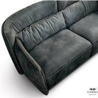 Closed up top view of black leather Tulip sofa with orange stitched detailing.