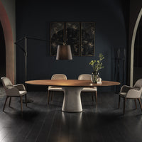Podium Dining Table with concrete oval base and wooden round top. Placed in a room with four matching dining chairs.