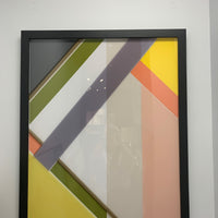 Abstract Wall Art Piece with glass and black frame.