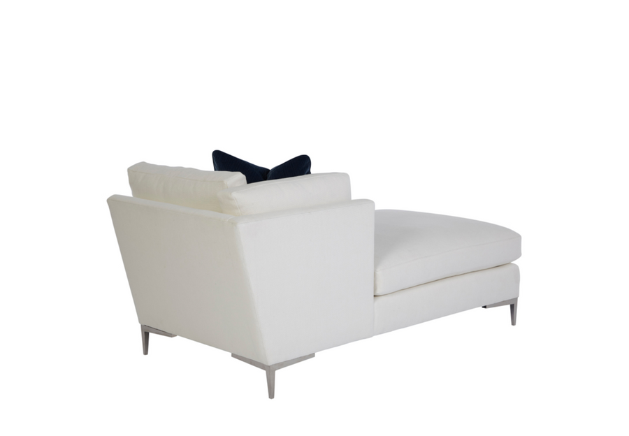 A white Aiden Chaise with metal legs and a blue pillow on it, side back view.