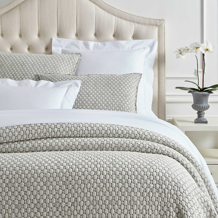 Lodi Matelassé bedding Collection with stonewashed design in a pattern of cool grey placed on a bed.