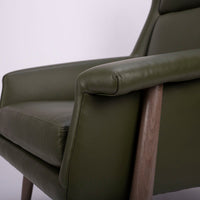 A green lounge chair designed in 1959 by Milo Baughman with solid walnut frame. Closed up side view.