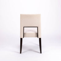 Blues Side Chair in white color fabric and dark legs, with open back, back view.