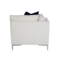 A white Aiden Chaise with metal legs and a blue pillow on it, back view.
