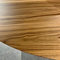 Fixed round Clessidra Dining Table with solid black steel base and wooden top. Closed up view of the wooden top.