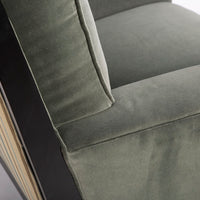 Curtis lounge chair in grey-green color with clean wood detail, softly splayed legs, and outside back framed by the wood trim, closed up side view.