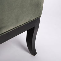 Curtis lounge chair in grey-green color with clean wood detail, softly splayed legs, and outside back framed by the wood trim, cloesd up bottom view.