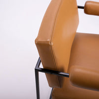 Classic modern leather dining chair designed in 1968 by Milo Baughman. Orange color with black metal frame.