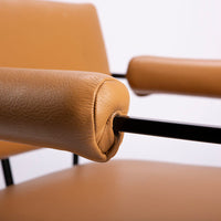 Classic modern leather dining chair designed in 1968 by Milo Baughman. Orange color with black metal frame.