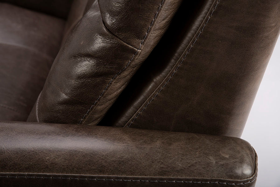 Closed up view of the armrest and back of recliner.