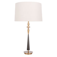 Morrison Lamp with a round Antique Brass base, white drum shade and candlestick silhouette body that combines Antique Brass with Matte Black.