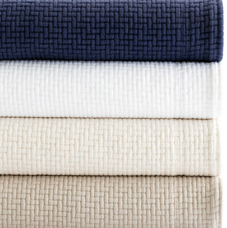 Color selection of the Interlaken Matelassé Coverlet - blue, white, beige and brown.