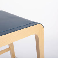 Tosca Barstool with blue leather seating and solid beechwood construction. Closed up bottom side view.