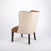 Goodman brown leather chair with curved back, textured woven fabric outside back. Side and back view.