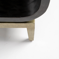 Wilhelm console that offers texture in the graphite gesso material, curvature for framing and a classic metal base to feature the unique design. Closed up bottom view.
