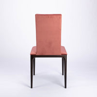 A red four seasons dining chair crafted from solid beechwood. Back view.