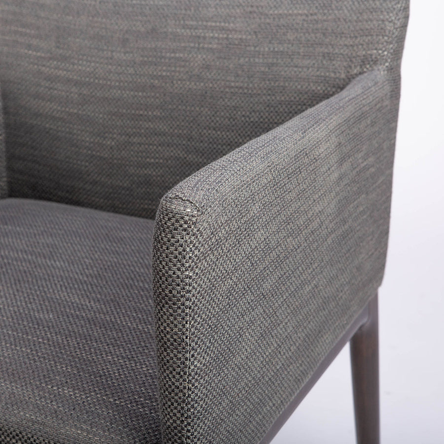 A grey four seasons dining chair crafted from solid beechwood. Closed up side view.