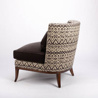 Beautifully shaped brown armless lounge chair with a curved back and seat rail, and saber shaped legs. Side and back view.