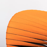 Orange and black Seat Belt dining chair with colorful seatbelt strappings, closed up seat view.