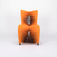 Orange and black Seat Belt dining chair with colorful seatbelt strappings, front view.