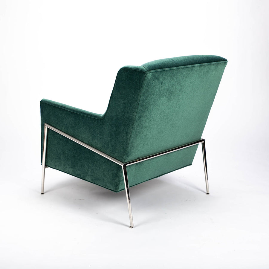 Green fabric Twiggy lounge chair with elegant leg detail in polished steel. Back and side view.