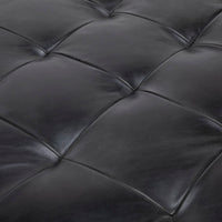 Tufted round ottoman by Cisco Brothers in top navy leather. Closed up seat view.