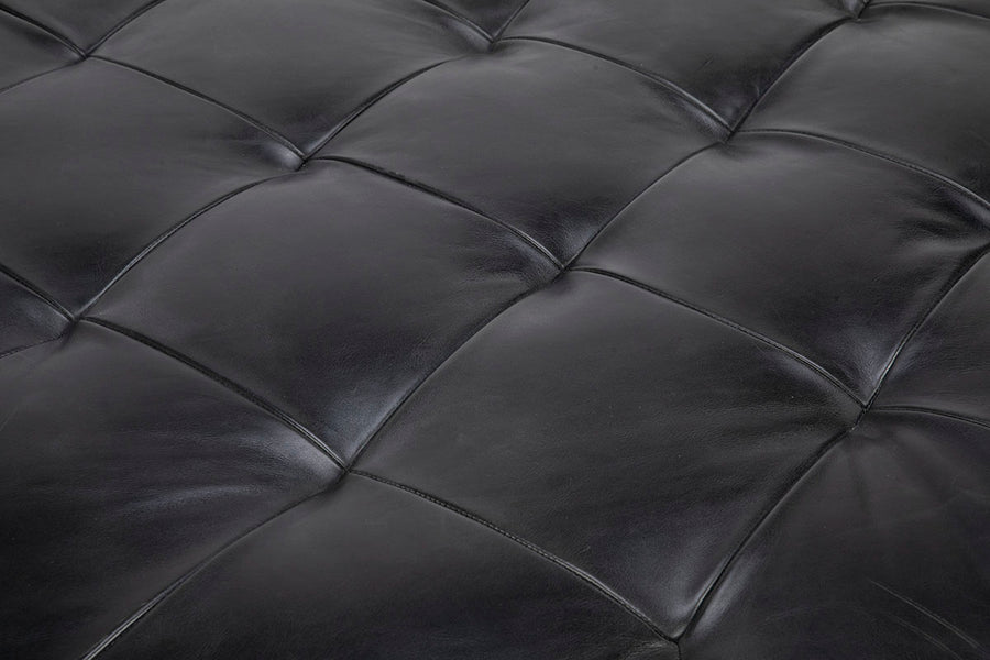 Tufted round ottoman by Cisco Brothers in top navy leather. Closed up seat view.