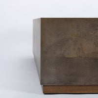Brown Cabo Cocktail Table block shaped in an abstract metal material, closed up view.