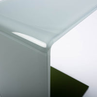 Two-toned bent glass coffee table with glued mat stainless steel plate. Closed up view on top.