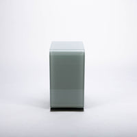Two-toned bent glass coffee table with glued mat stainless steel plate.