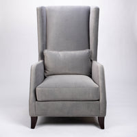 A light grey Rob lounge chair with extra high back, subtle angles and clean shape in the wing detail, front view.