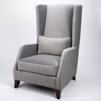 A light grey Rob lounge chair with extra high back, subtle angles and clean shape in the wing detail.