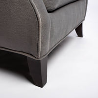 A light grey Rob lounge chair with extra high back, subtle angles and clean shape in the wing detail, closed up bottom view.