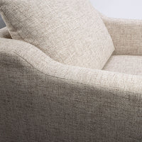 A white fabric Tea lounge stocked chair, closed up side view.