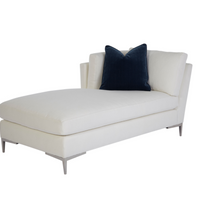 A white Aiden Chaise with metal legs and a blue pillow on it.