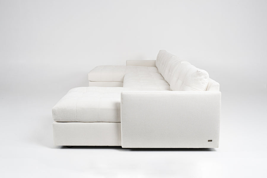 Large white u-shaped Carmet Sectional with sleek track arms. Side view.