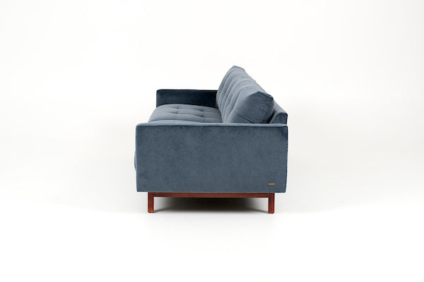 Blue two seat Carmet sofa by American Leather with modernist track arms that taper in from the top of the sofa to the bottom. Side view.
