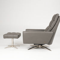 A grey leather Huron recliner and lounge chair with natural walnut four-star base, side view with ottoman.
