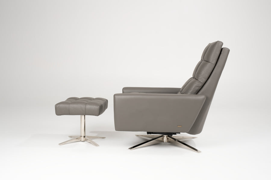 A grey leather Huron recliner and lounge chair with natural walnut four-star base, side view with ottoman.
