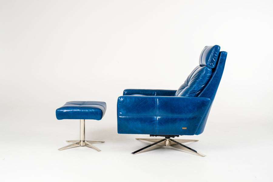 A blue leather recliner chair with four star base and ottoman, side view.
