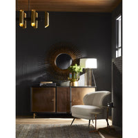 Brown Addison Accent Table made of leather and metal with bi-tonal finished brass and top with brushed finish. placed in a modern room next to a white chair.