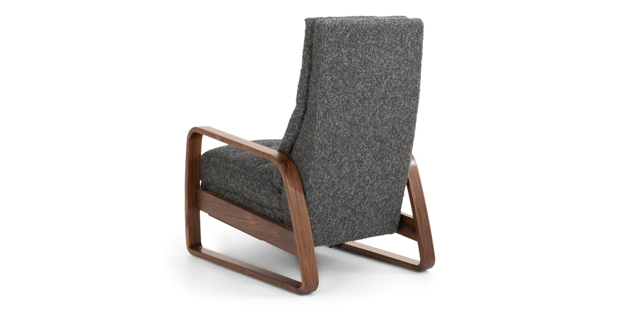 The Elton XT recliner by American Leather with wooden arms formed into soft geometric shapes, down-filled channel-tufted back and seat cushions. Grey color, back and side view.