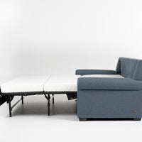 American Leather Gibbs Two Seat Standard (Queen) Comfort Sofa bed in indigo color with high tapered wood legs, left side view, pulled-out.