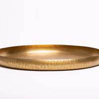 Hand-embossed brass tray.