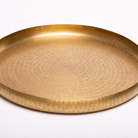 Hand-embossed brass tray.