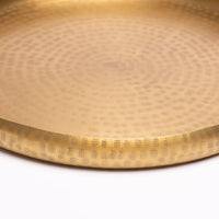Hand-embossed brass tray.