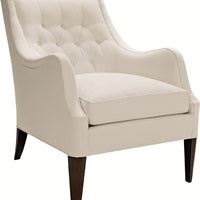 A white Ludlow lounge chair with softly diamond-tufted back resting on elegantly on tapered posts and Dark Walnut finish.