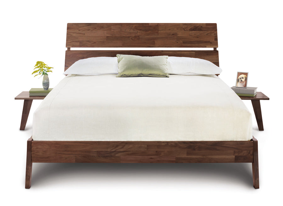 Linn queen size bed crafted from reclaimed walnut hardwood with contemporary design, front view, with bedside tables.