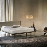 The Nelson designer modern king size bed with a light shape, placed in a modern room, front and side view.