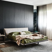 The Nelson designer modern king size bed with a light shape, placed in a modern room, front and side view.